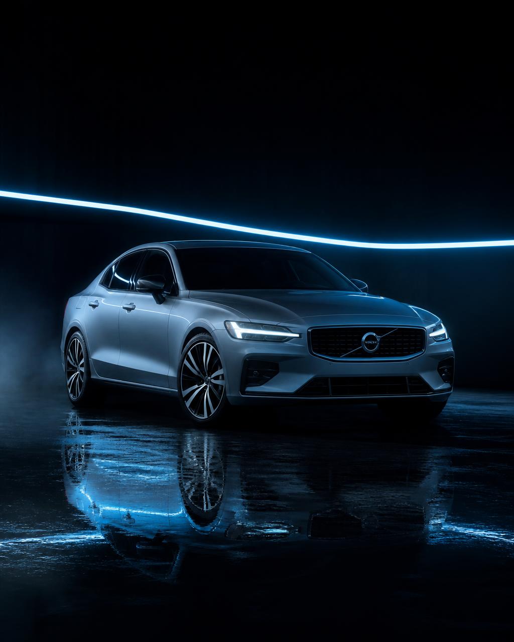 Silver sedan lit by blue studio light